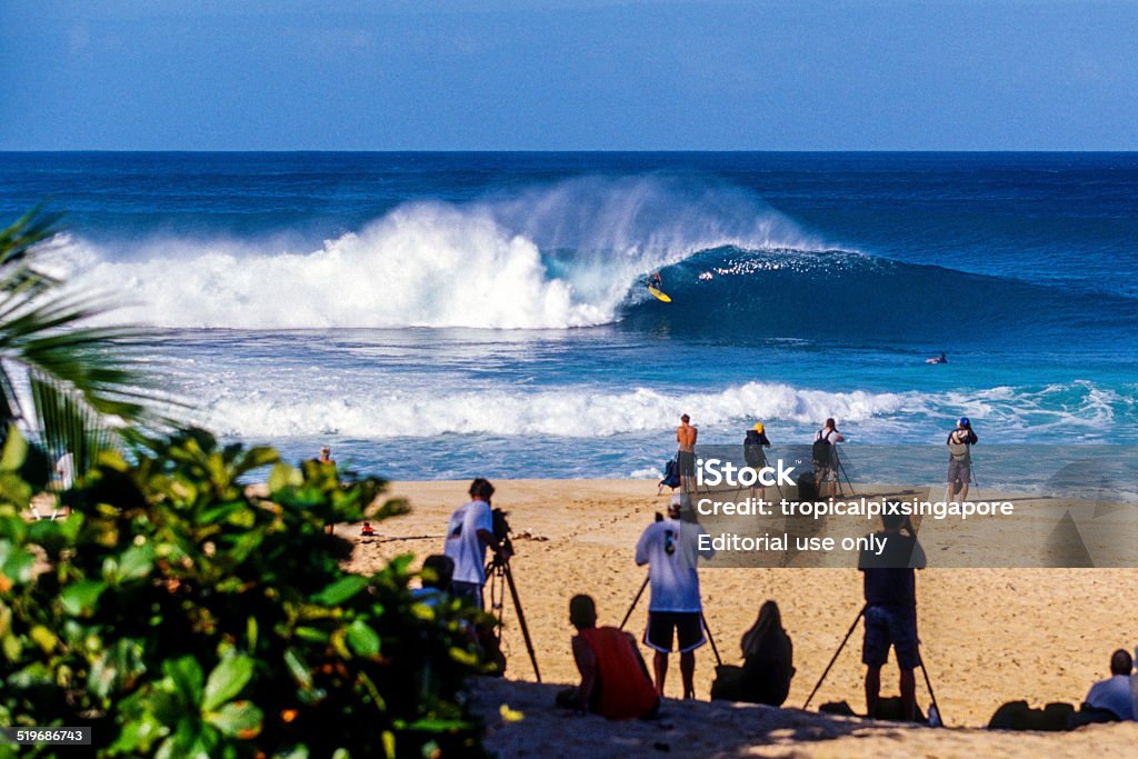 Surfing at Pipeline Haleiwa, Hawaii, USA – December 3, 2001: Surfing at the Pipeline, on Oahu's North Shore. The north shore is famous for big waves in the winter surf season. Hawaii Islands Stock Photo