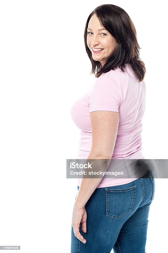 Back view of woman looking back Smiling woman turned and looking over his shoulder Adult Stock Photo