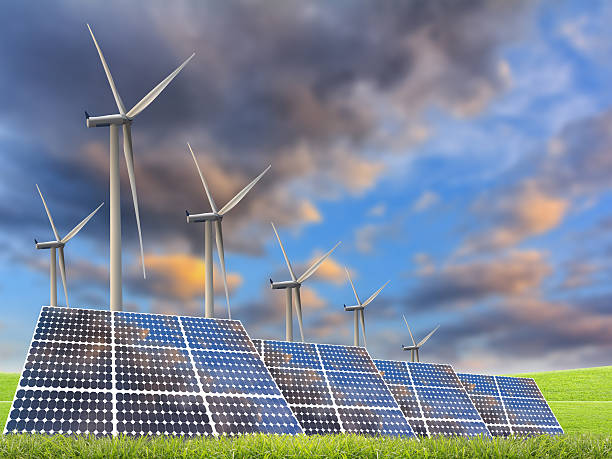 istock solar energy panels and wind turbine in sunset. 519687471
