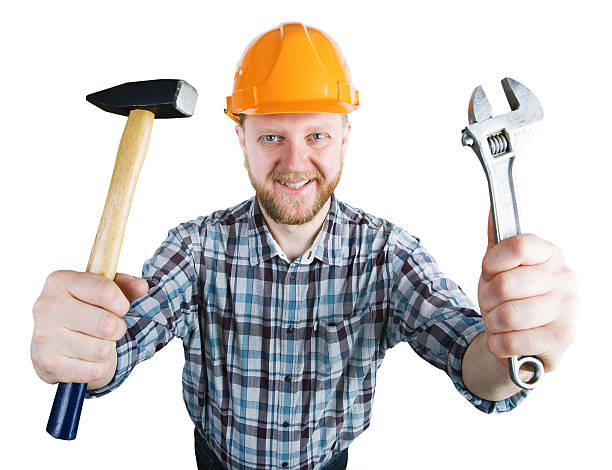 istock Man in the helmet with a hammer, wrench 519688616