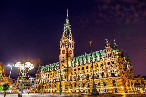 istock townhall in Hamburg by night 519689043