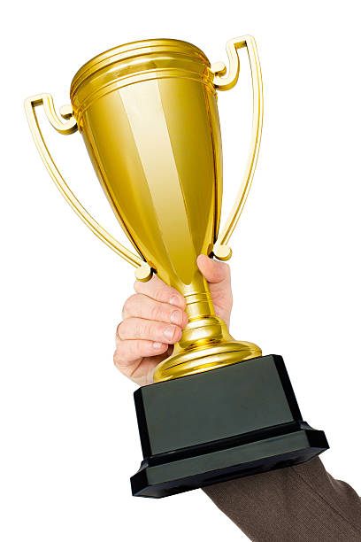 istock Businessmans hand holding sport cup 519689740