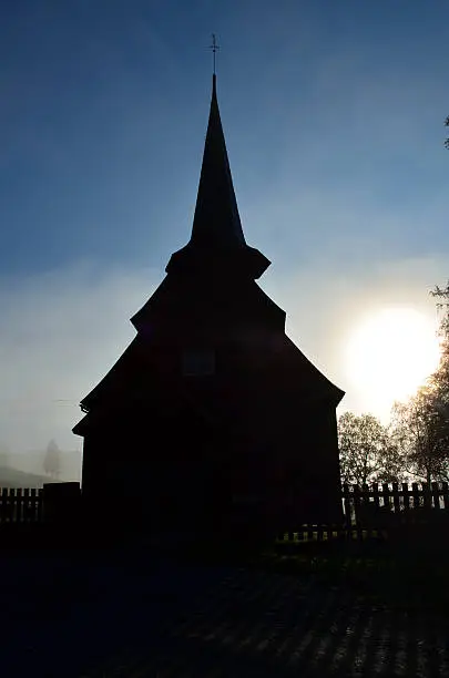 old stavechurch in morninglight, norway