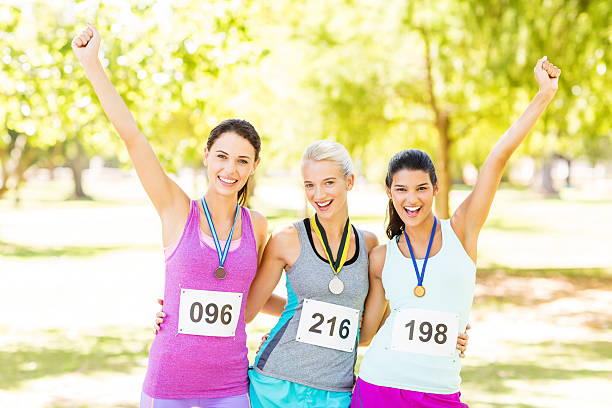 istock Successful Marathon Runners With Medals In Park 519702247