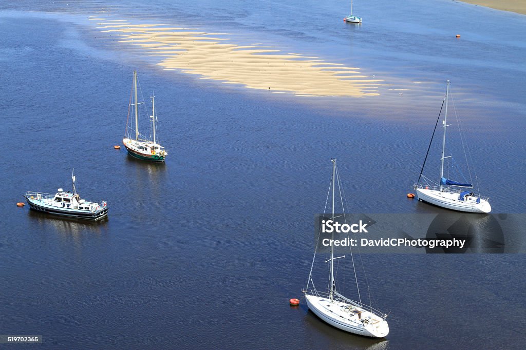 Yacht Moorings In Tidal Estuary Beautiful colour tones and ripples as a contrasting sandbank is covered by the incomming tide of an Estuary with yacht moorings Conwy Stock Photo