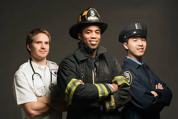 Police officer, paramedic and fireman, on black background, portrait