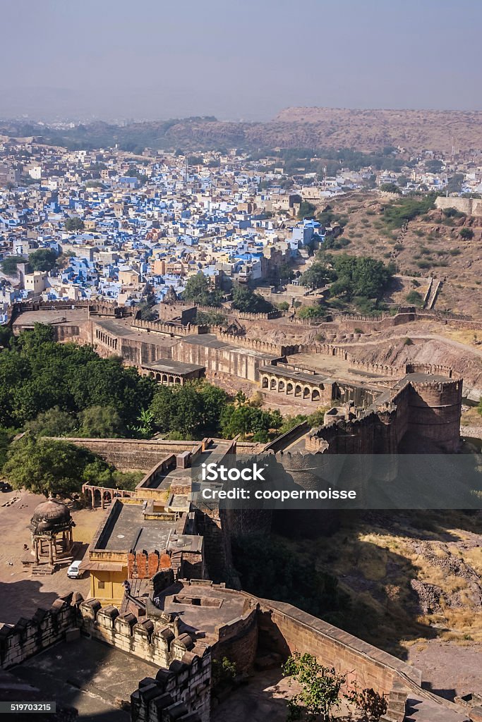 Blue City of Jodhpur, Rajasthan, India from Meherangarh Fort Vertical An aerial view of the Blue City of Jodhpur, Rajasthan, India from Meherangarh Fort with fort wall turrets and structure in foreground Aerial View Stock Photo