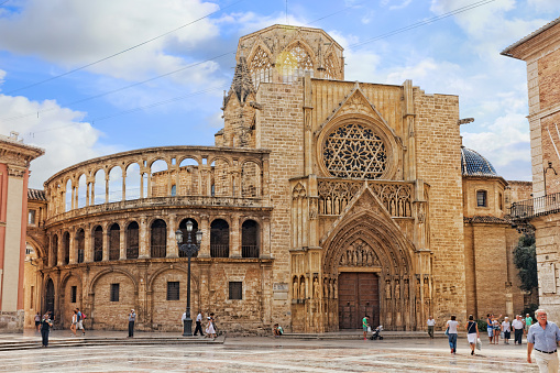 Valencia, Spain - September 10, 2014: Square of Saint Mary's and Valencia  Cathedral Temple in old town. Every year,Valencia(third size population  city in Spain)welcomes more than 4 million visitors.