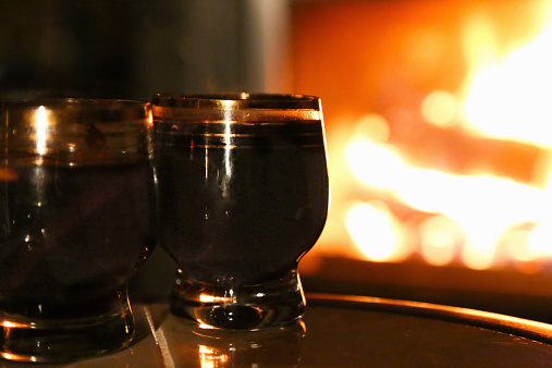 glasses of mulled wine on a background of fire