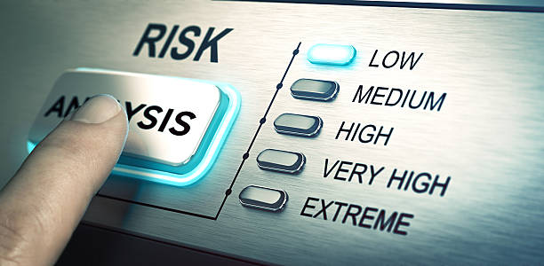 Risks analyze, low risk man finger about to press an analysis push button. Focus on the blue led. Concept image for illustration of risk management or assessment. risk stock pictures, royalty-free photos & images