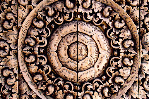 A teak wood carving of a flower from southern of Thailand
