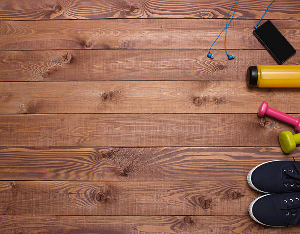 istock Sport accessories  on the right side, copy space wooden background 519707900