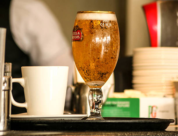 Bournemouth, England - March 7, 2016: A pint of beer and a mug sit on a tray in a coffee shop in Bournemouth