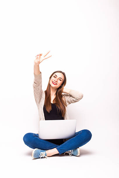 istock Happy black woman with arms raised and computer 519711186