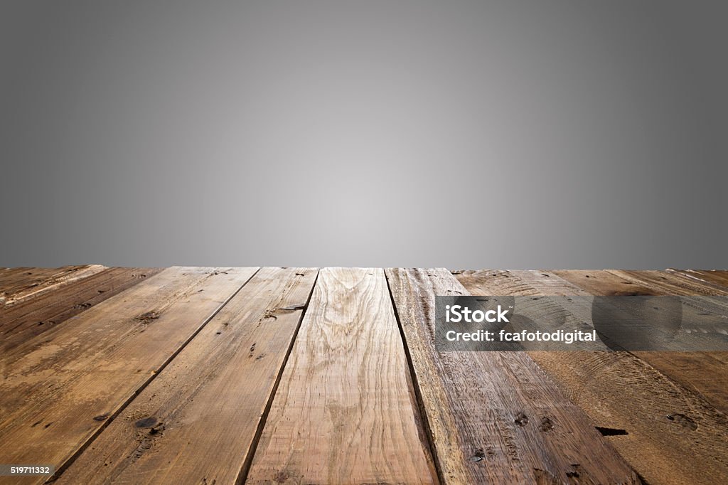 Empty wood table with gray background Empty wood table with gray background. Ideal for product display on top of the table. Table Stock Photo