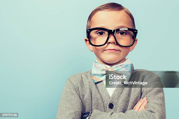 Young Nerd Boy Folding Arms And Blank Expression Stock Photo - Download Image Now - Nerd, Child, Eyeglasses