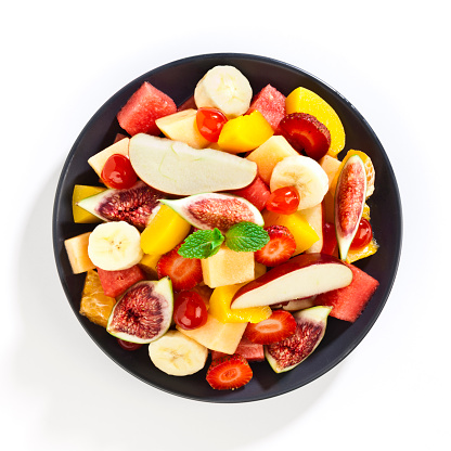 Top view of colorful fruit salad in a gray plate shot on white background. DSRL Studio photo taken with Canon EOS 5D Mark II and EF100mm f/2.8L Macro IS USM Lens