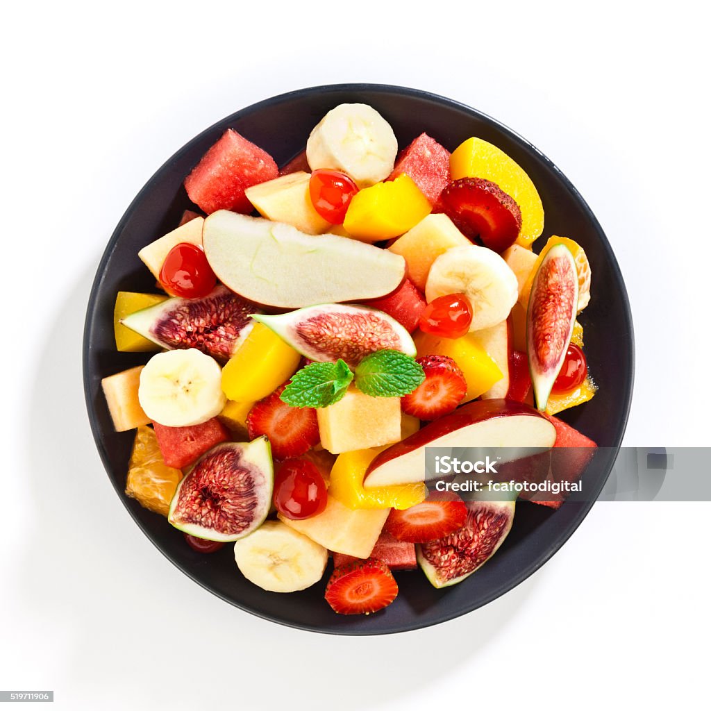 Fruit salad Top view of colorful fruit salad in a gray plate shot on white background. DSRL Studio photo taken with Canon EOS 5D Mark II and EF100mm f/2.8L Macro IS USM Lens Fruit Stock Photo
