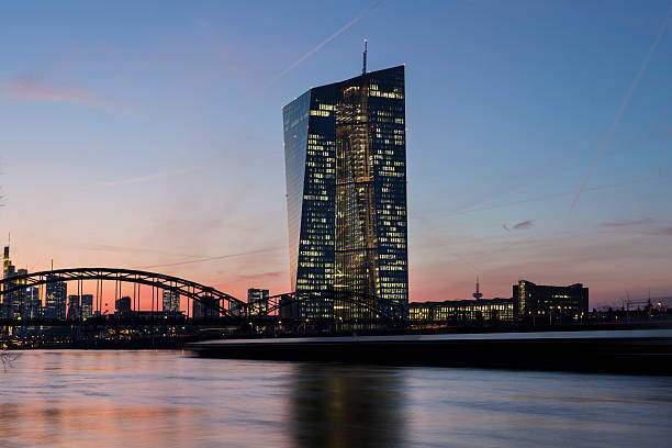 European Central Bank with the skyline of Frankfurt, Germany - in the foreground a cargo ship passing by, long exposure