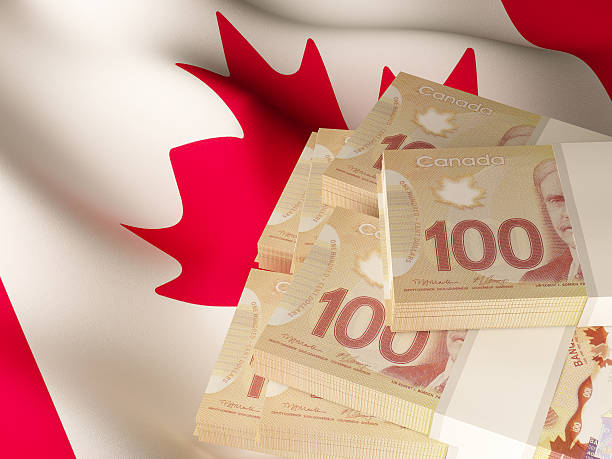 istock Canadian dollar banknotes over Canada flag 519716610