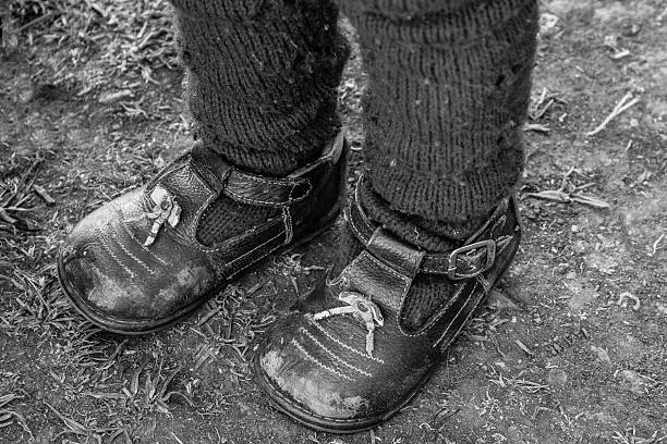 istock Worn out shoes - childhood Peru 519718302