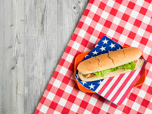 coloque plano de sándwich en mesa de día de campo con placa de plástico - napkin american flag holiday fourth of july fotografías e imágenes de stock