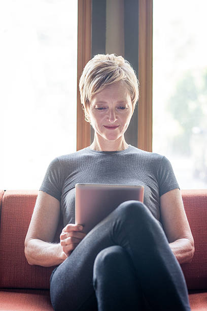 istock Woman Reading Her Digital Tablet 519721045