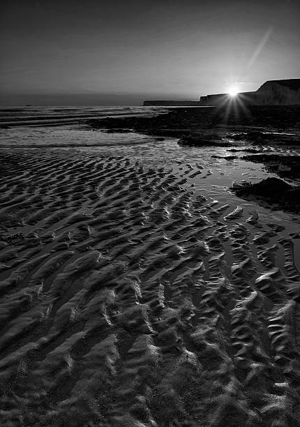 istock Long exposure landscape rocky shoreline at sunset black and white 519721689