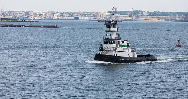 istock Green and White Tug Boat in New York Harbor 519722085