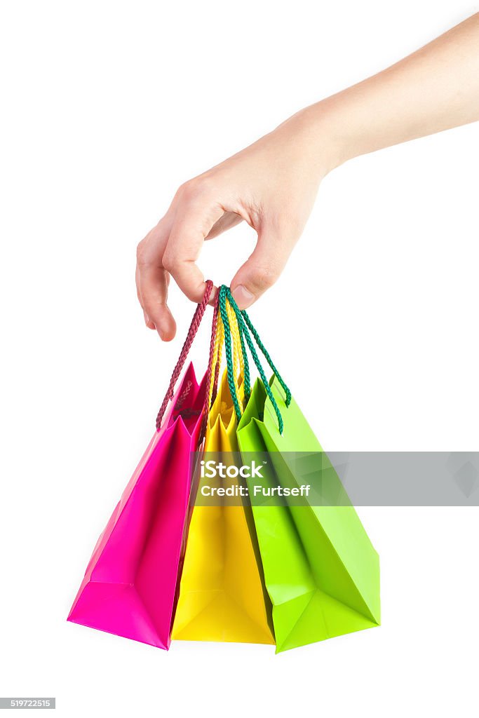 Gift bags in hand Hand holding gift bags on white background Adult Stock Photo