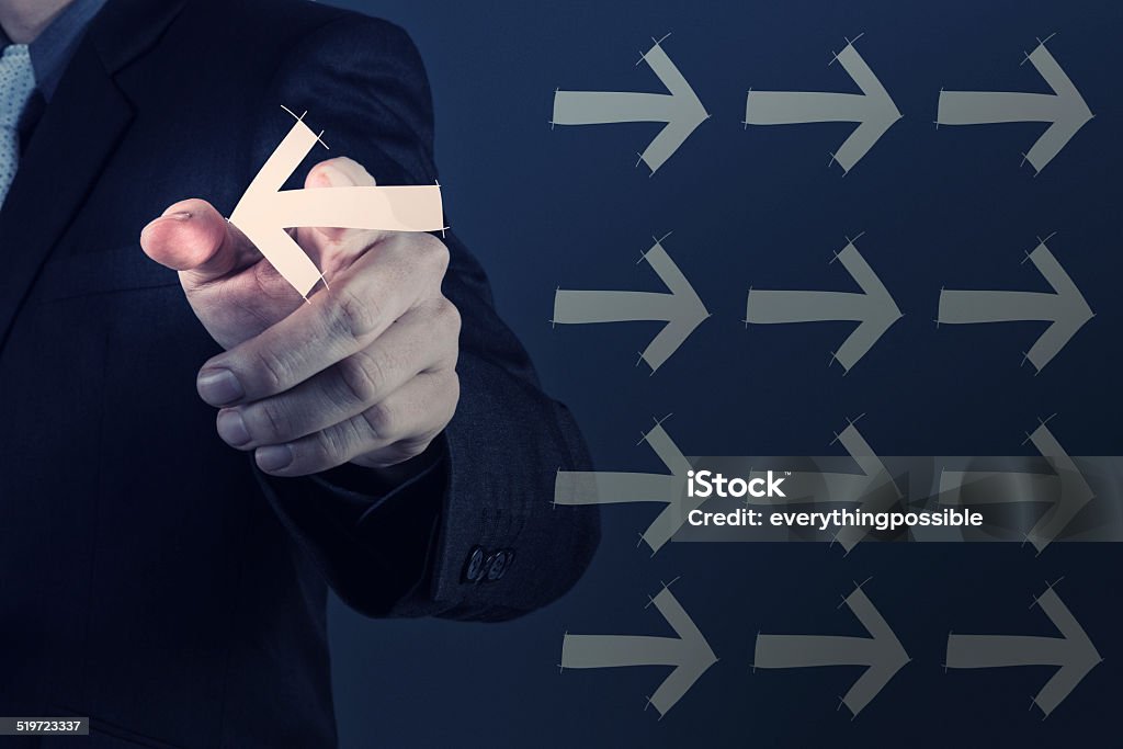 Businessman hand selecting different arrows Businessman hand selecting different arrows as leadership concept Adult Stock Photo