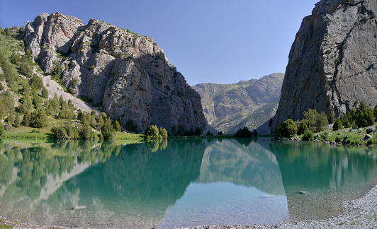Green lake Chukurak is arrounded with rocks. Fann Mountains (also known as the Fanns) are part of the western Pamir-Alay mountain system and are located in Tajikistan's Sughd Province .