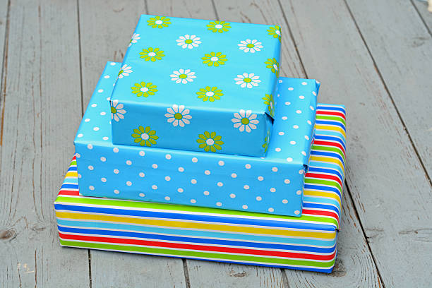 istock Three colored gifts on wood 519726413