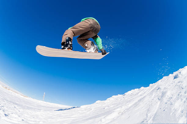 istock Snowboarder jumping against blue sky 519728976