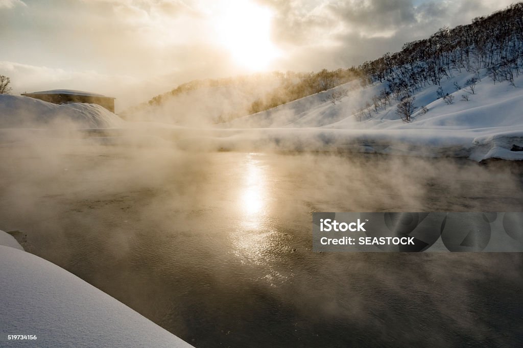Sunny Day Natural Mountain Hot Springs Sun Shines Through Steam at Natural Volcanic Hot Springs in Hokkaido, Japan Hot Spring Stock Photo