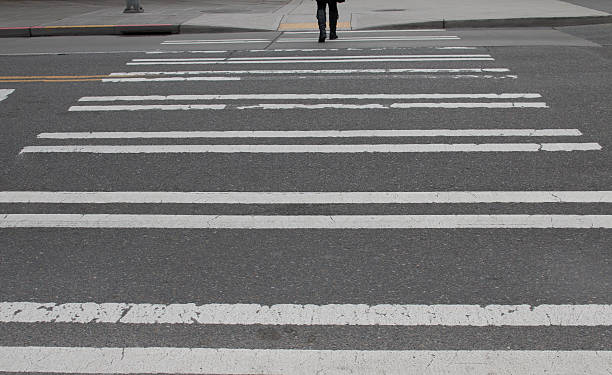 istock Woman walking away on crosswalk 519739374