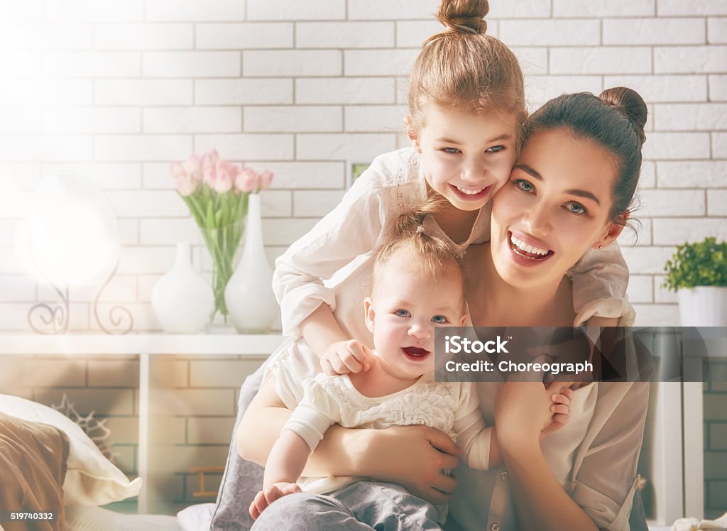 Happy loving family Happy loving family. Mother and her daughters children girls playing and hugging. Baby - Human Age Stock Photo