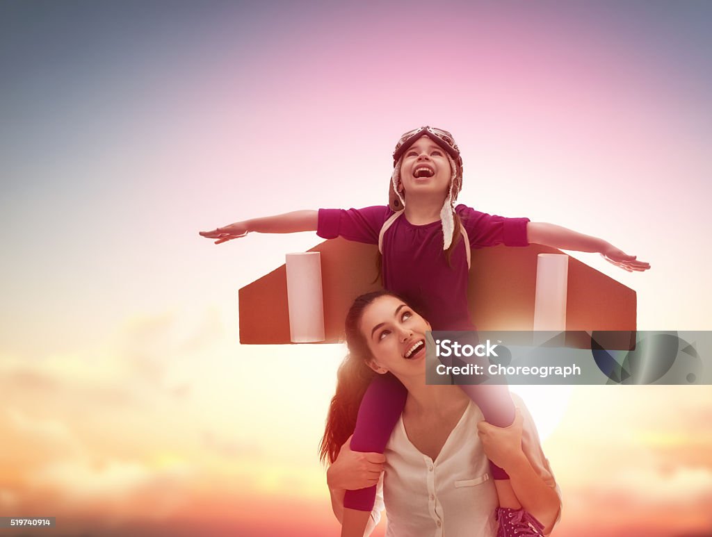 Happy loving family Mother and her child playing together. Little child girl plays astronaut. Child in an astronaut costume plays and dreams of becoming a spaceman. Happy loving family having fun. Mother Stock Photo