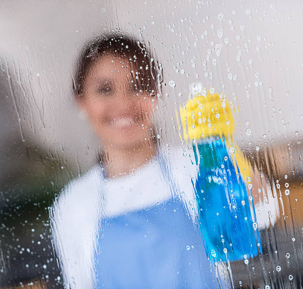 istock Woman cleaning the window 519746021