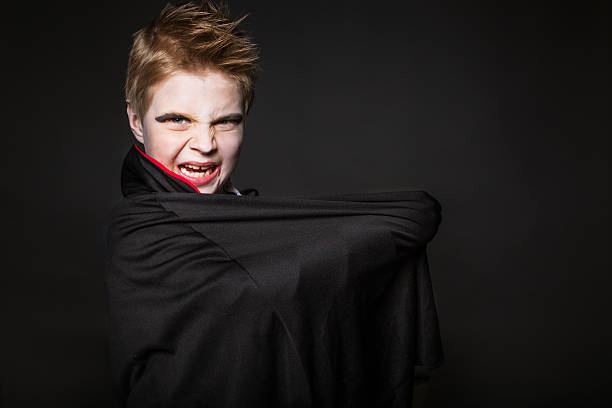 istock Cute boy dressed up as vampire for the halloween party 519746907