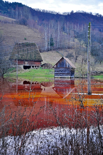 An abandoned house flooded by polluted water from a copper open cast mine