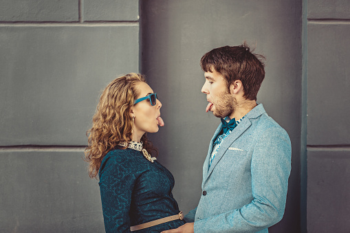 Portrait of happy hipster couple in love with tongues