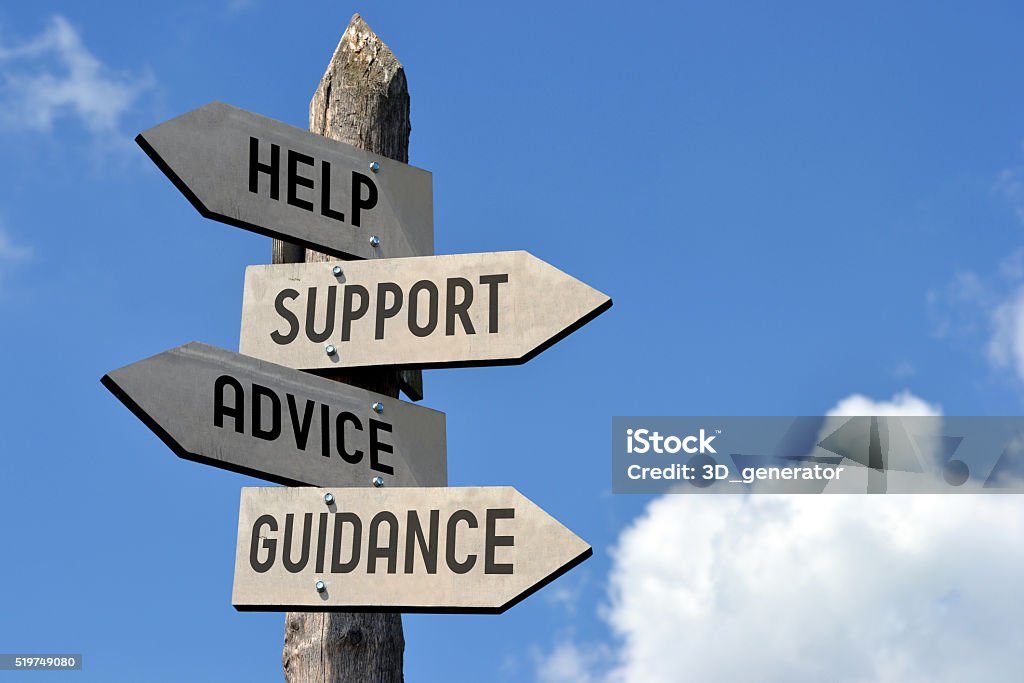 Help, support, advice, guidance signpost Wooden singpost with "help, support, advice, guidance" arrows against blue sky. Support Stock Photo