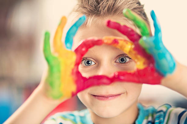 istock Happy little boy painting with hands 519750258