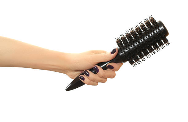 istock Round hair brush in hand 519750965