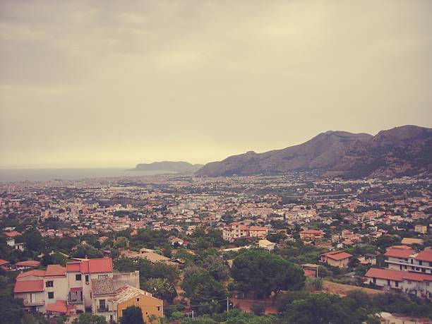 Panoramic view on the city of Palermo from Monreale hill, on a cloudy summer day. Image filtered in faded, retro, Instagram style; nostalgic concept of summer travel.