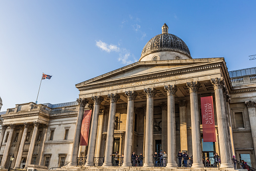 London, UK - March 2, 2016: National Gallery building at Trafalgar square with people in London, UK. Founded in 1824, it houses a collection of over 2,300 paintings dating from the mid-13th century to 1900.