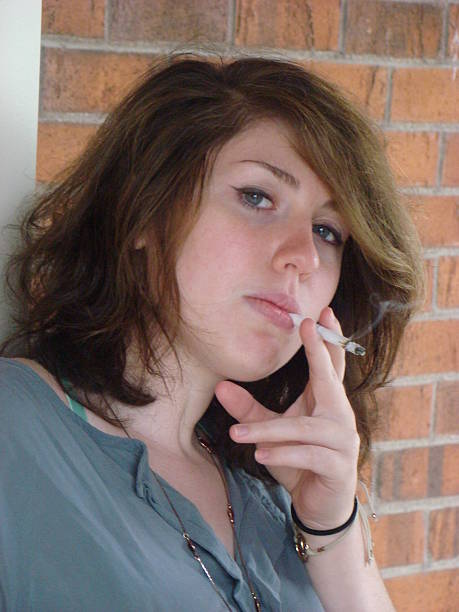 istock Attractive young female smoking 519751391