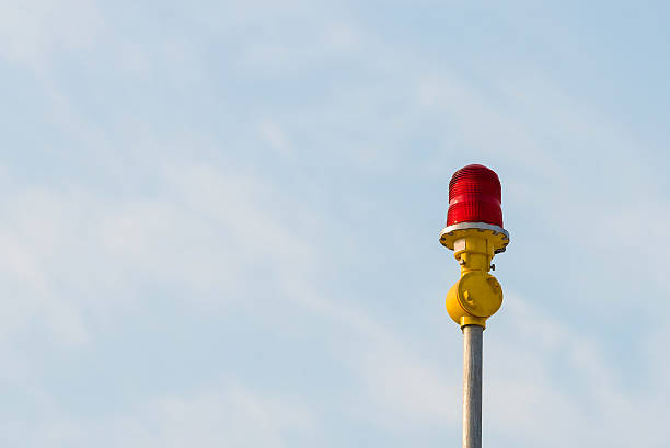istock Red aircraft warning lights with blue sky background 519752654