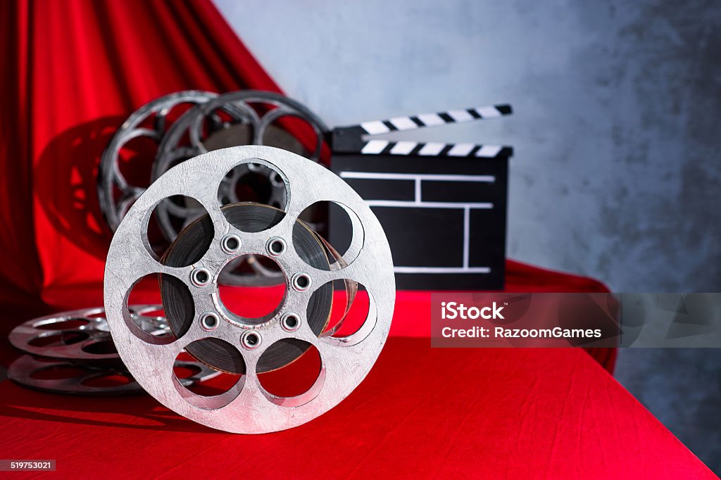 cinema Cinema clapper and reel on the background of red curtain Film Reel Stock Photo